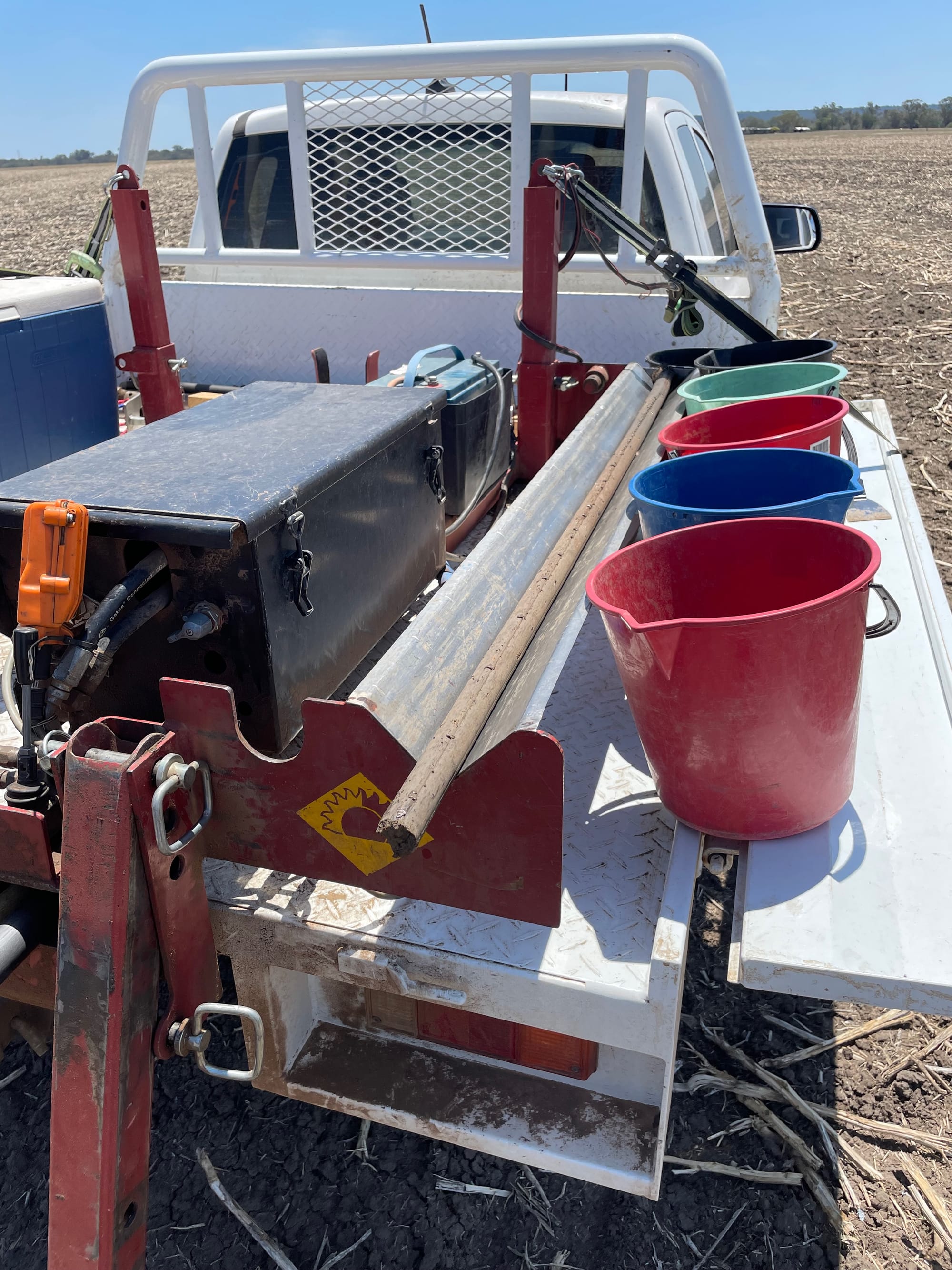 Soil testing equipment on the back of a ute with a soil core on the tray.