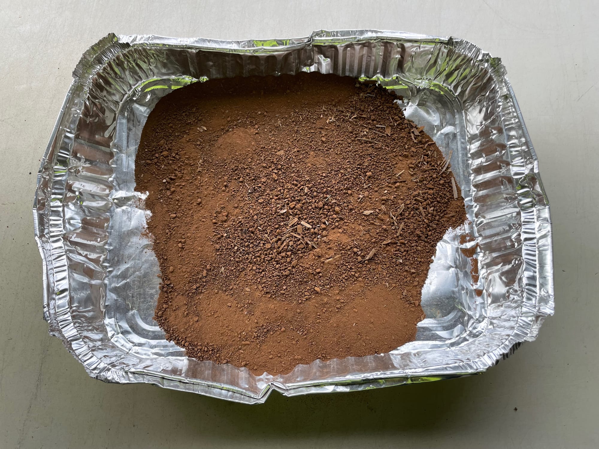 Soil in aluminium tray after being put through grinding machine.