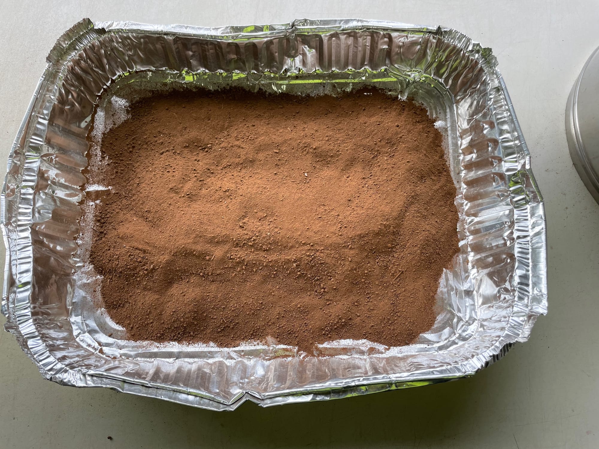 Soil in aluminium tray after sample was ground and sieved.